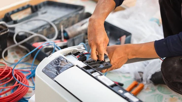 Technician preparing and checking the components of an indoor air conditioner
